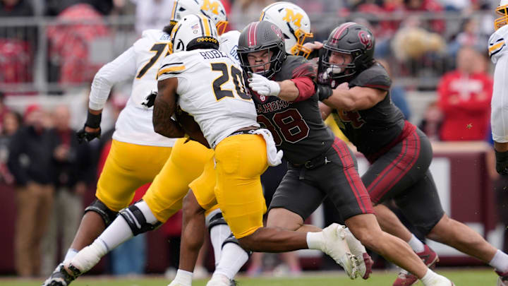 Oklahoma Sooners linebacker Owen Heinecke (38) brings down Missouri Tigers running back Jamal Roberts (20) during a college football game between the University of Oklahoma Sooners (OU) and the Missouri Tigers at Gaylord Family Ð Oklahoma Memorial Stadium in Norman, Okla., on Saturday, Nov. 22, 2025. Oklahoma won 17-6.