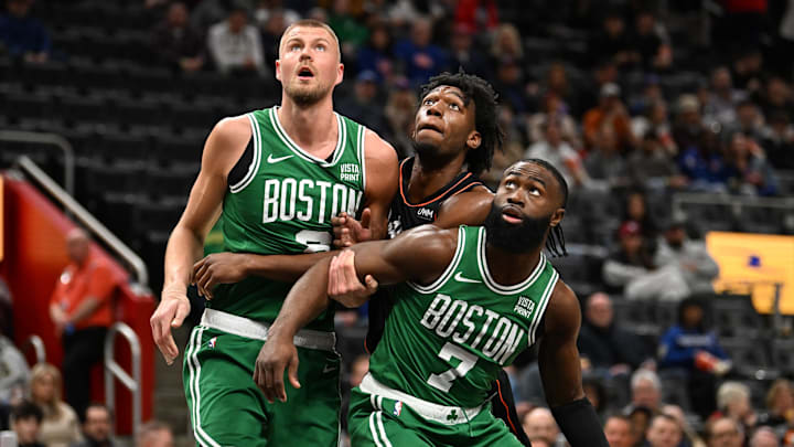 Mar 22, 2024; Detroit, Michigan, USA; Detroit Pistons center James Wiseman (13) center, battles for position on the foul line against Boston Celtics center Kristaps Porzingis (8) (left) and guard Jaylen Brown (7) in the first quarter at Little Caesars Arena. Mandatory Credit: Lon Horwedel-Imagn Images