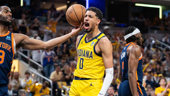 May 12, 2024; Indianapolis, Indiana, USA;  Indiana Pacers guard Tyrese Haliburton (0) celebrates a made basket while New York Knicks guard Alec Burks (18) defends during game four of the second round for the 2024 NBA playoffs at Gainbridge Fieldhouse. Mandatory Credit: Trevor Ruszkowski-Imagn Images