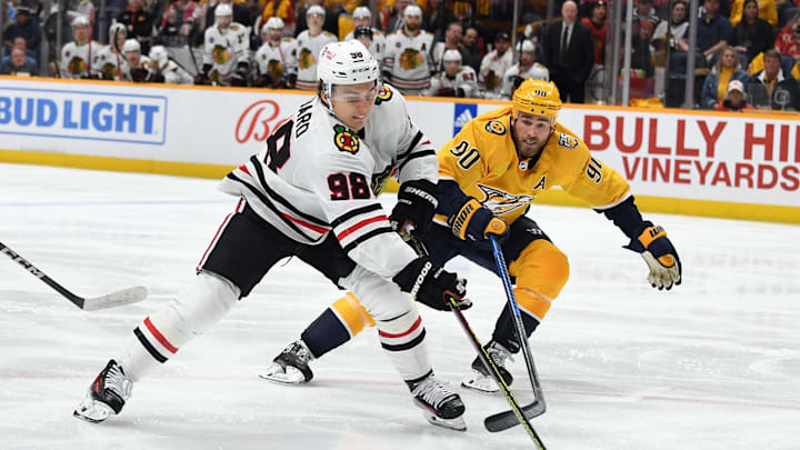 Jan 2, 2024; Nashville, Tennessee, USA; Chicago Blackhawks center Connor Bedard (98) handles the puck against Nashville Predators center Ryan O'Reilly (90) during the second period at Bridgestone Arena. Mandatory Credit: Christopher Hanewinckel-Imagn Images