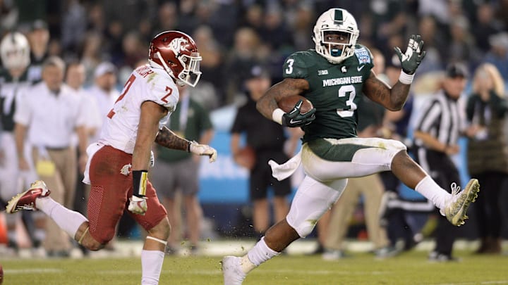 Dec 28, 2017; San Diego, CA, USA; Michigan State Spartans running back LJ Scott (3) runs for a touchdown against Washington State Cougars defensive back Robert Taylor (2) during the fourth quarter in the 2017 Holiday Bowl at SDCCU Stadium. Mandatory Credit: Orlando Ramirez-Imagn Images