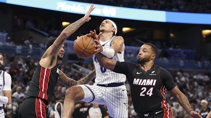 Oct 22, 2025; Orlando, Florida, USA; Miami Heat guard Norman Powell (24) strips the ball from Orlando Magic guard Anthony Black (0) in the fourth quarter at Kia Center. Mandatory Credit: Nathan Ray Seebeck-Imagn Images