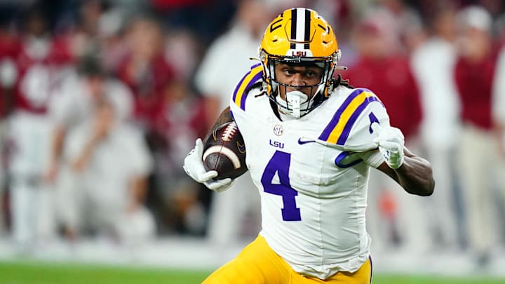 Nov 4, 2023; Tuscaloosa, Alabama, USA; LSU Tigers running back John Emery Jr. (4) carries the ball against the Alabama Crimson Tide during the second quarter at Bryant-Denny Stadium. Mandatory Credit: John David Mercer-USA TODAY Sports