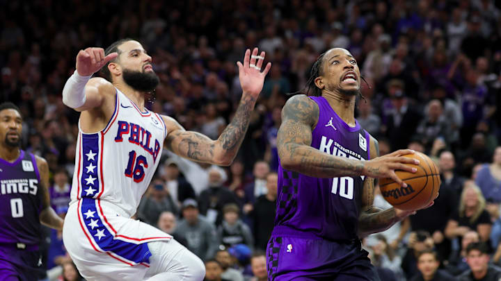 Jan 1, 2025; Sacramento, California, USA; Sacramento Kings forward DeMar DeRozan (10) drives to the basket against Philadelphia 76ers forward Caleb Martin (16) during the fourth quarter at Golden 1 Center. Mandatory Credit: Sergio Estrada-Imagn Images Jan 1, 2025; Sacramento, California, USA; Sacramento Kings forward DeMar DeRozan (10) drives to the basket against Philadelphia 76ers forward Caleb Martin (16) during the fourth quarter at Golden 1 Center. Mandatory Credit: Sergio Estrada-Imagn Images