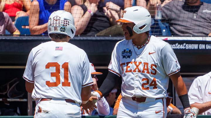 Texas Longhorns shortstop Adrian Rodriguez (24) greets third baseman Casey Borba (31) after Borba scored a run on a single against the Alabama Crimson Tide during the second inning at Charles Schwab Field. 