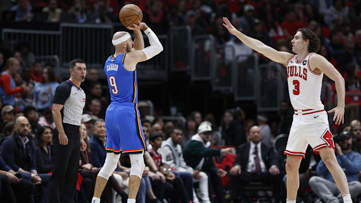 Oct 26, 2024; Chicago, Illinois, USA; Oklahoma City Thunder guard Alex Caruso (9) shoots against Chicago Bulls guard Josh Giddey (3) during the first half at United Center. Mandatory Credit: Kamil Krzaczynski-Imagn Images