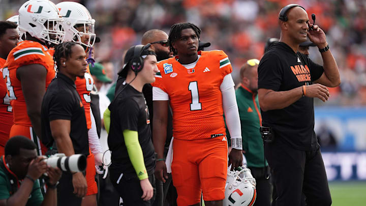 Dec 28, 2024; Orlando, FL, USA; Miami Hurricanes quarterback Cam Ward (1) stands on the sideline during the first half against the Iowa State Cyclones at Camping World Stadium. Mandatory Credit: Jasen Vinlove-Imagn Images Dec 28, 2024; Orlando, FL, USA; Miami Hurricanes quarterback Cam Ward (1) stands on the sideline during the first half against the Iowa State Cyclones at Camping World Stadium. Mandatory Credit: Jasen Vinlove-Imagn Images