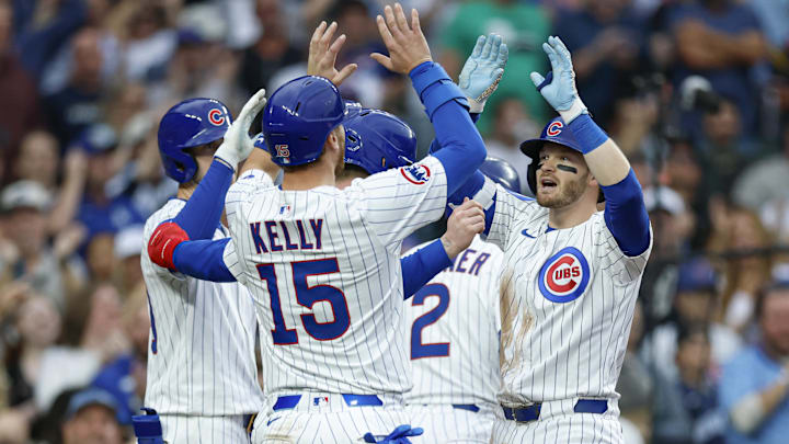 Apr 18, 2025; Chicago, Illinois, USA; Chicago Cubs outfielder Ian Happ (8) celebrates with teammates after hitting a grand slam against the Arizona Diamondbacks during the seventh inning at Wrigley Field. 