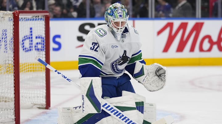 Jan 11, 2025; Toronto, Ontario, CAN; Vancouver Canucks goaltender Kevin Lankinen (32) makes a save against the Toronto Maple Leafs during the third period at Scotiabank Arena. Mandatory Credit: John E. Sokolowski-Imagn Images