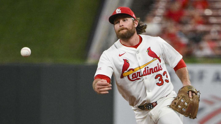 Aug 11, 2025; St. Louis, Missouri, USA;  St. Louis Cardinals second baseman Brendan Donovan (33) flips the ball to first base during the ninth inning against the Colorado Rockies at Busch Stadium. Mandatory Credit: Jeff Curry-Imagn Images