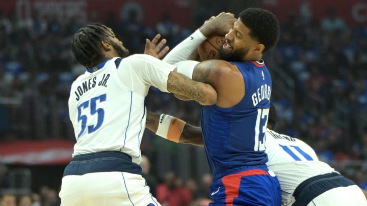 Dallas Mavericks forward Derrick Jones Jr. (55) and Los Angeles Clippers forward Paul George (13) fight for the ball in the first half during game one of the first round for the 2024 NBA playoffs against the Dallas Mavericks at Crypto.com Arena. Mandatory Credit: Dallas Mavericks forward Derrick Jones Jr. (55) and Los Angeles Clippers forward Paul George (13) fight for the ball in the first half during game one of the first round for the 2024 NBA playoffs against the Dallas Mavericks at Crypto.com Arena. Mandatory Credit: