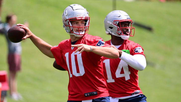 Jun 12, 2024; Foxborough, MA, USA; New England Patriots quarterback Drake Maye (10) and quarterback Jacob y Brissett (14) throw passes at minicamp at Gillette Stadium. Mandatory Credit: Eric Canha-USA TODAY Sports Jun 12, 2024; Foxborough, MA, USA; New England Patriots quarterback Drake Maye (10) and quarterback Jacob y Brissett (14) throw passes at minicamp at Gillette Stadium. Mandatory Credit: Eric Canha-USA TODAY Sports