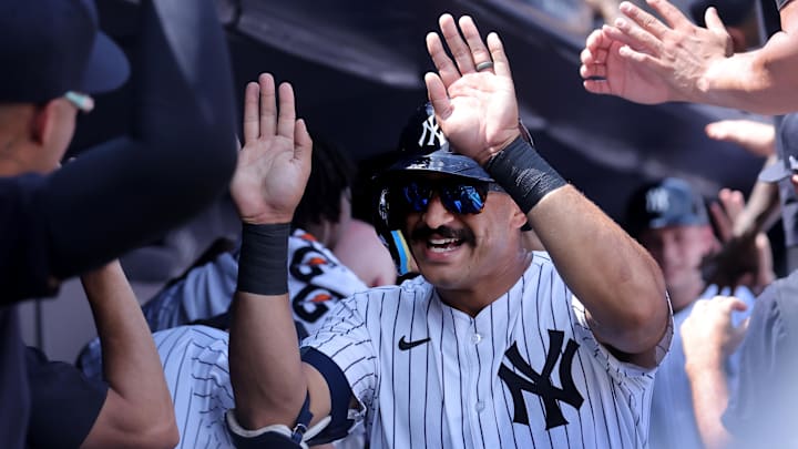 Aug 3, 2024; Bronx, New York, USA; New York Yankees center fielder Trent Grisham (12) celebrates his two run home run against the Toronto Blue Jays with teammates in the dugout during the second inning at Yankee Stadium. Mandatory Credit: Brad Penner-Imagn Images