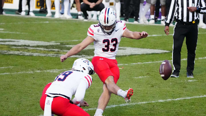 Nov 11, 2023; Boulder, Colorado, USA; Arizona Wildcats place kicker Tyler Loop (33) kicks the winning field goal in the fourth quarter against the Colorado Buffaloes at Folsom Field. Mandatory Credit: Ron Chenoy-Imagn Images