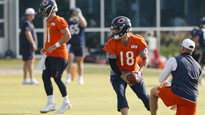 Caleb Williams looks to hand off in training camp warmups. Caleb Williams looks to hand off in training camp warmups.