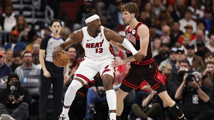 Nov 21, 2025; Chicago, Illinois, USA; Chicago Bulls forward Matas Buzelis (14) defends against Miami Heat center Bam Adebayo (13) during the first half at United Center. Mandatory Credit: Kamil Krzaczynski-Imagn Images