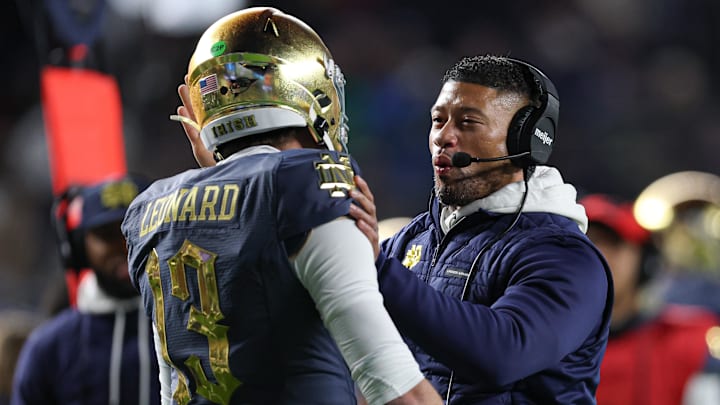 Nov 23, 2024; New York, New York, USA; Notre Dame Fighting Irish head coach Marcus Freeman celebrates with quarterback Riley Leonard (13) after a touchdown during the first half against the Army Black Knights at Yankee Stadium. Mandatory Credit: Vincent Carchietta-Imagn Images