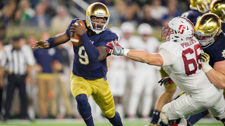 Oct 15, 2016; South Bend, IN, USA; Notre Dame Fighting Irish quarterback Malik Zaire (9) is pressured by Stanford Cardinal defensive tackle Harrison Phillips (66) in the third quarter at Notre Dame Stadium. Stanford won 17-10. Mandatory Credit: Matt Cashore-Imagn Images