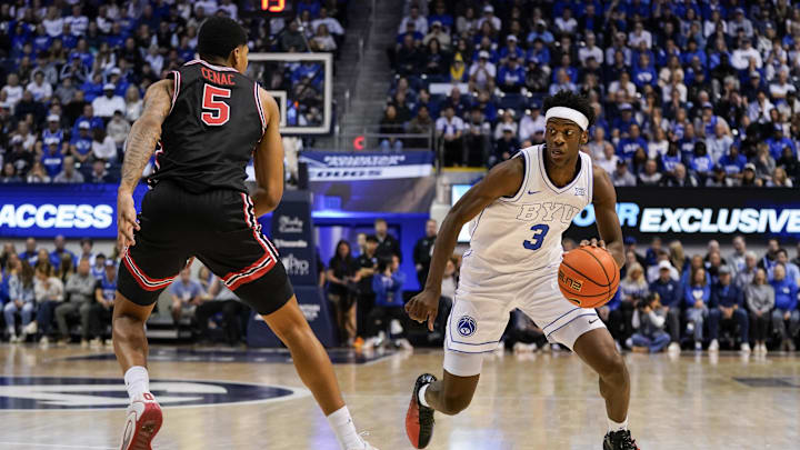 Feb 7, 2026; Provo, Utah, USA; BYU Cougars forward AJ Dybantsa (3) controls the ball while being defended by Houston Cougars forward Chris Cenac Jr. (5) during the first half at Marriott Center. Mandatory Credit: Aaron Baker-Imagn Images