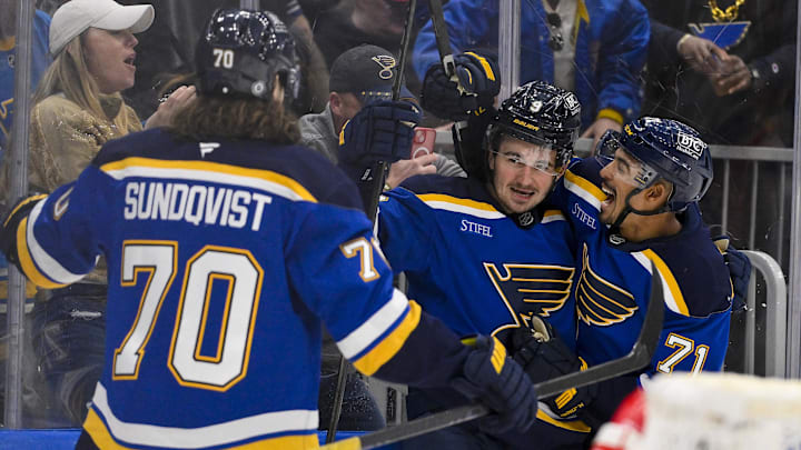 Mar 25, 2025; St. Louis, Missouri, USA;  St. Louis Blues center Alexandre Texier (9) is congratulated by right wing Mathieu Joseph (71) and center Oskar Sundqvist (70) after scoring against the Montreal Canadiens during the second period at Enterprise Center. Mandatory Credit: Jeff Curry-Imagn Images