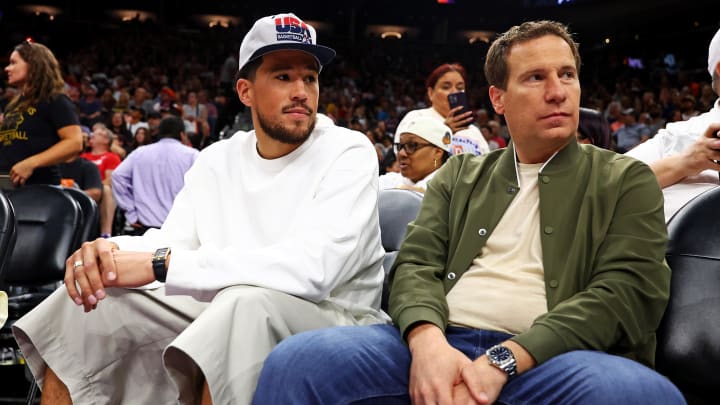 Jun 30, 2024; Phoenix, Arizona, USA; Phoenix Suns guard Devon Booker sits with Phoenix Mercury owner Mat Ishbia during the game between the Indiana Fever and the Phoenix Mercury at Footprint Center. Mandatory Credit: Mark J. Rebilas-USA TODAY Sports
