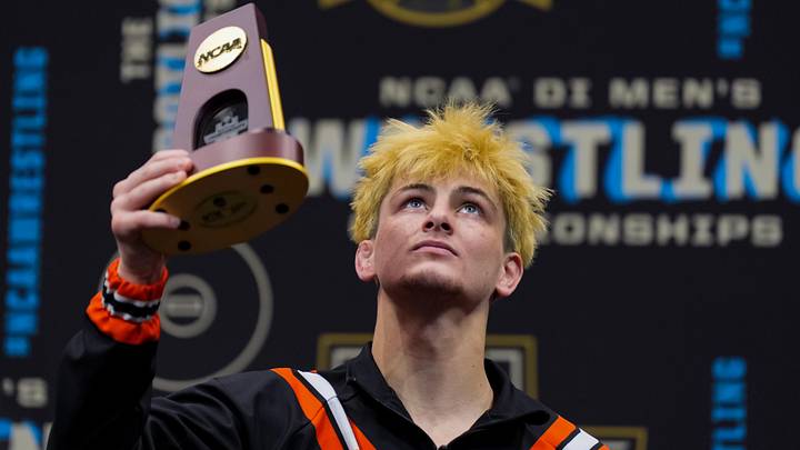 Oklahoma State Cowboys Jax Forrest holds his national championship trophy.