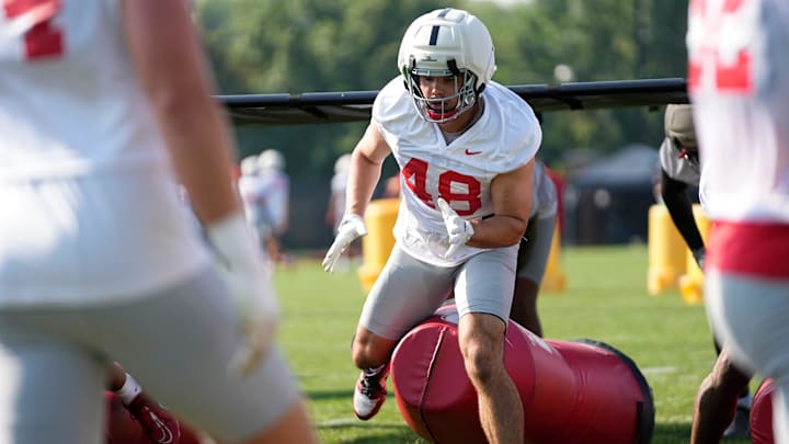 Ohio State Buckeyes defensive lineman Logan George (48) hits a tackling dummy during football training camp at the Woody Hayes Athletic Center on Aug. 1, 2025.