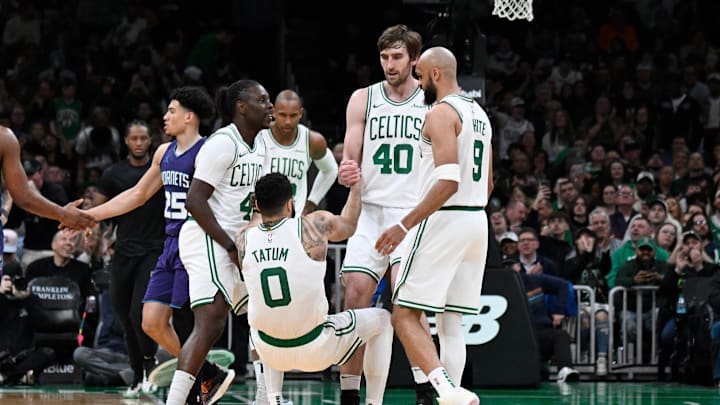 Apr 11, 2025; Boston, Massachusetts, USA; Boston Celtics guard Jrue Holiday (4) and .center Luke Kornet (40) help forward Jayson Tatum (0) to his feet during the second half against the Charlotte Hornets at TD Garden. Mandatory Credit: Eric Canha-Imagn Images