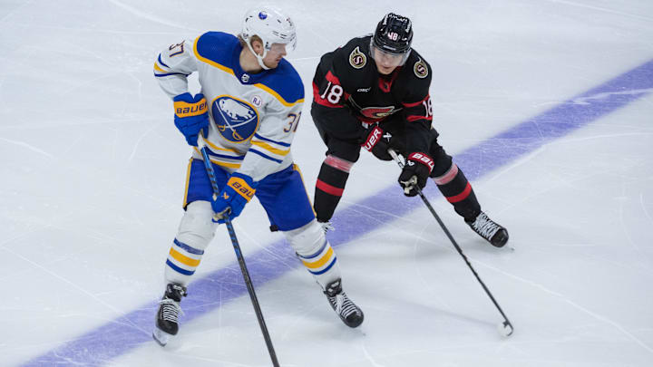 Dec 31 2023; Ottawa, Ontario, CAN; Buffalo Sabres center Casey Mittelstadt (37) battles with Ottawa