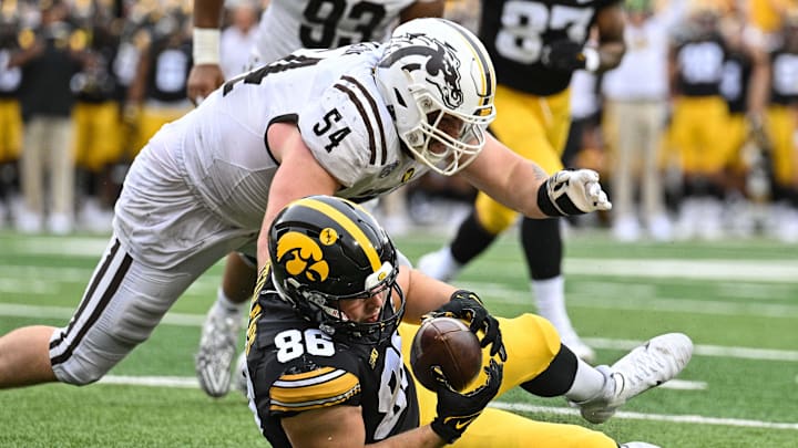 Iowa Hawkeyes tight end Steven Stilianos (86) and Western Michigan Broncos defensive lineman Mason Nelson (54) in action during the game at Kinnick Stadium.