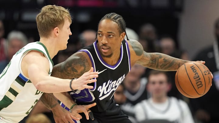 Sacramento Kings forward DeMar DeRozan (right) dribbles against Milwaukee Bucks guard AJ Green (left) during the first quarter at Golden 1 Center on March 22.