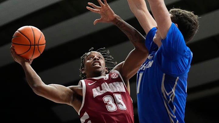Dec 14, 2024; Tuscaloosa, AL, USA; Alabama forward Derrion Reid (35) goes to the basket against Creighton center Ryan Kalkbrenner (11) at Coleman Coliseum. Alabama defeated Creighton 83-75. Mandatory Credit: Gary Cosby Jr.-Tuscaloosa News