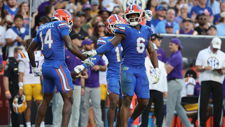 Nov 16, 2024; Gainesville, Florida, USA; Florida Gators linebacker Shemar James (6) and defensive back Jordan Castell (14) high five against the LSU Tigers during the first half at Ben Hill Griffin Stadium. Mandatory Credit: Kim Klement Neitzel-Imagn Images