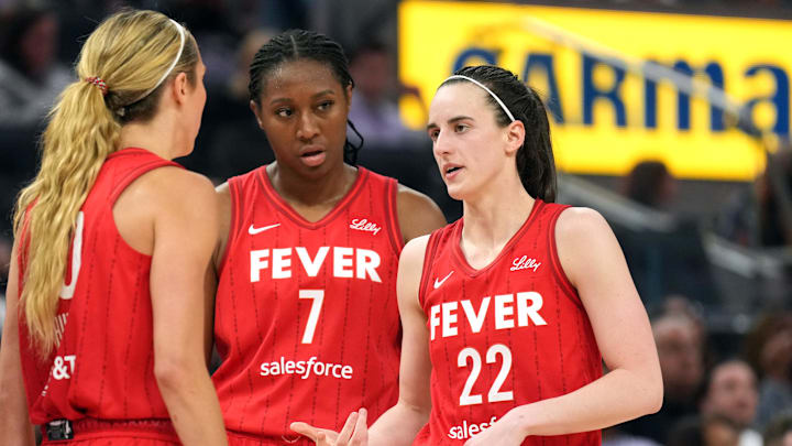 Jun 19, 2025; San Francisco, California, USA; Indiana Fever guard Caitlin Clark (22) talks to guard Lexie Hull (left) and forward Aliyah Boston (7) during the third quarter against the Golden State Valkyries at Chase Center. Mandatory Credit: Darren Yamashita-Imagn Images