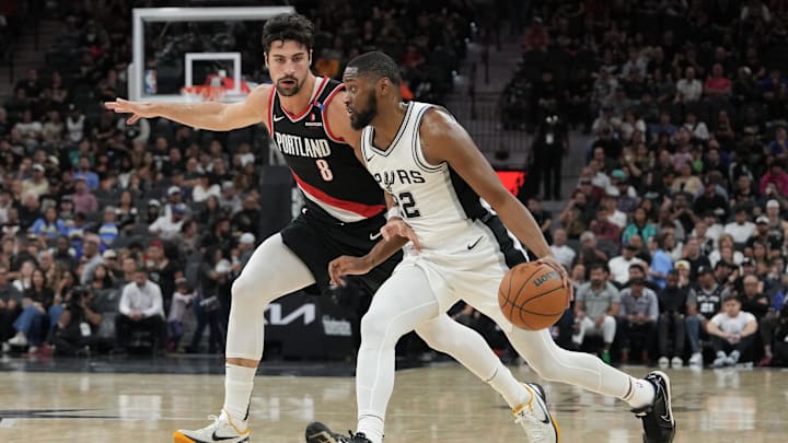 Nov 7, 2024; San Antonio, Texas, USA;  San Antonio Spurs guard Malaki Branham (22) dribbles against Portland Trail Blazers forward Deni Avdija (8) in the first half at Frost Bank Center. Mandatory Credit: Daniel Dunn-Imagn Images