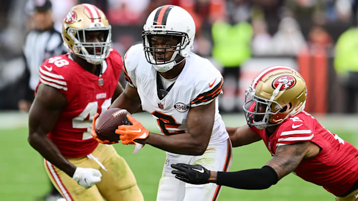 Oct 15, 2023; Cleveland, Ohio, USA; Cleveland Browns wide receiver Amari Cooper (2) runs with the ball after a catch as San Francisco 49ers cornerback Deommodore Lenoir (2) and linebacker Oren Burks (48) defend during the second half at Cleveland Browns Stadium. Mandatory Credit: Ken Blaze-Imagn Images