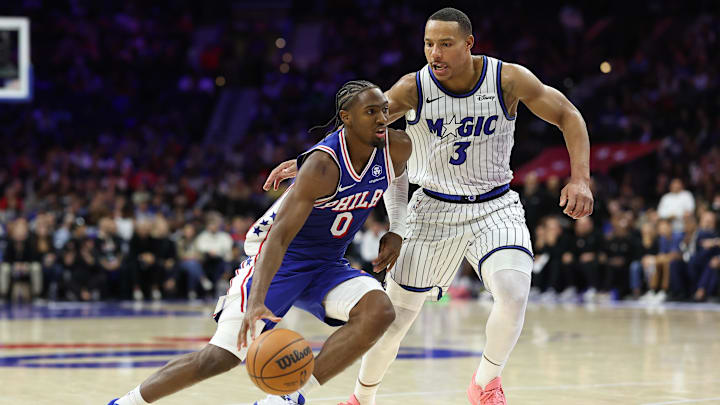 Oct 27, 2025; Philadelphia, Pennsylvania, USA; Philadelphia 76ers guard Tyrese Maxey (0) dribbles past Orlando Magic guard Desmond Bane (3) during the fourth quarter at Xfinity Mobile Arena. Mandatory Credit: Bill Streicher-Imagn Images
