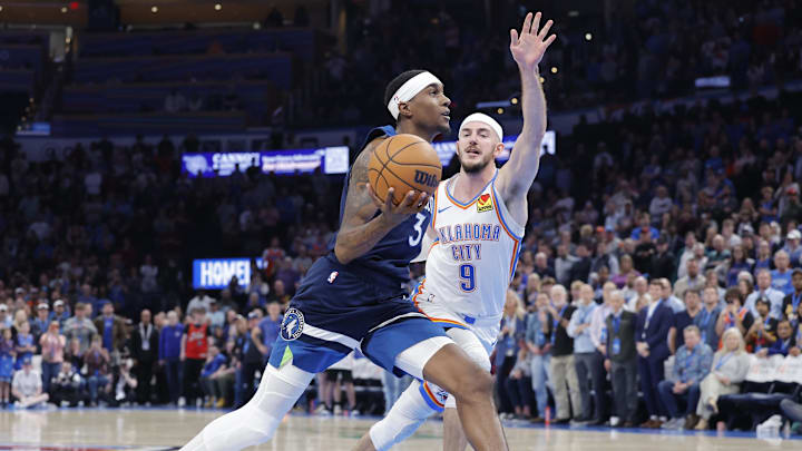 Feb 24, 2025; Oklahoma City, Oklahoma, USA; Minnesota Timberwolves forward Jaden McDaniels (3) drives to the basket beside Oklahoma City Thunder guard Alex Caruso (9) during the second half at Paycom Center. Feb 24, 2025; Oklahoma City, Oklahoma, USA; Minnesota Timberwolves forward Jaden McDaniels (3) drives to the basket beside Oklahoma City Thunder guard Alex Caruso (9) during the second half at Paycom Center.
