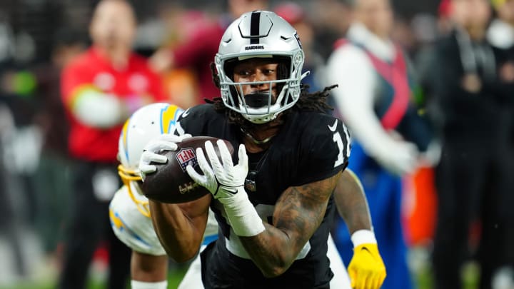 Dec 14, 2023; Paradise, Nevada, USA;  Las Vegas Raiders wide receiver Jakobi Meyers (16) makes a catch for a touchdown against the Los Angeles Chargers in the first quarter at Allegiant Stadium. Mandatory Credit: Stephen R. Sylvanie-USA TODAY Sports