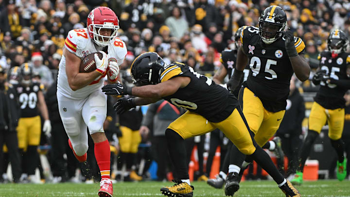Dec 25, 2024; Pittsburgh, Pennsylvania, USA; Kansas City Chiefs tight end Travis Kelce (87) looks to elude Pittsburgh Steelers linebacker Elandon Roberts (50) during the second half at Acrisure Stadium. Mandatory Credit: Barry Reeger-Imagn Images