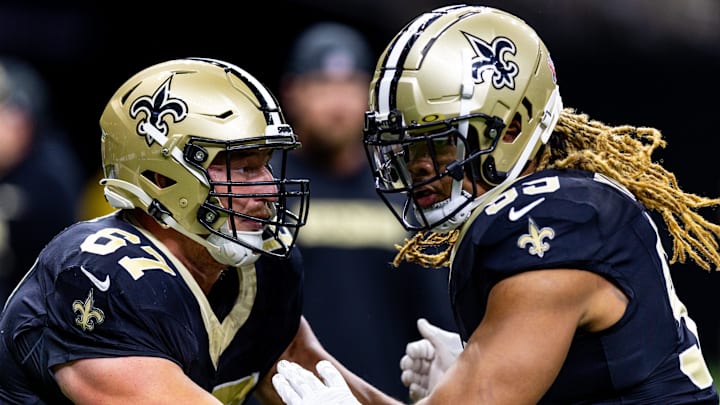 Sep 8, 2024; New Orleans, Louisiana, USA;  New Orleans Saints offensive tackle Landon Young (67) blocks defensive end Chase Young (99) against the Carolina Panthers during the pregame at Caesars Superdome. Mandatory Credit: Stephen Lew-Imagn Images