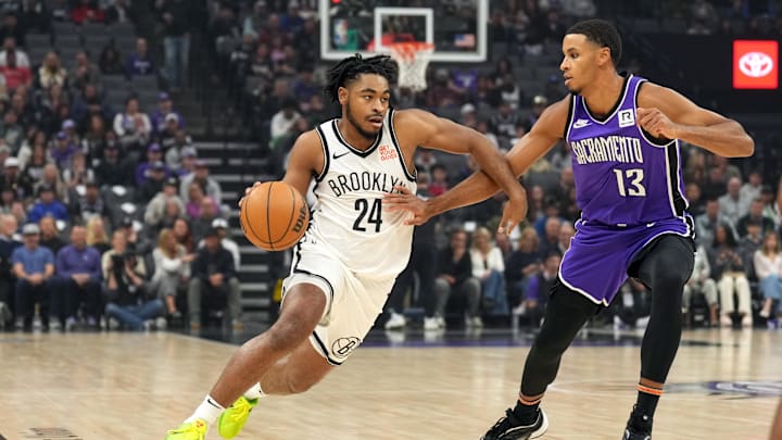 Nov 24, 2024; Sacramento, California, USA; Brooklyn Nets guard Cam Thomas (24) dribbles against Sacramento Kings forward Keegan Murray (13) during the first quarter at Golden 1 Center. Mandatory Credit: Darren Yamashita-Imagn Images