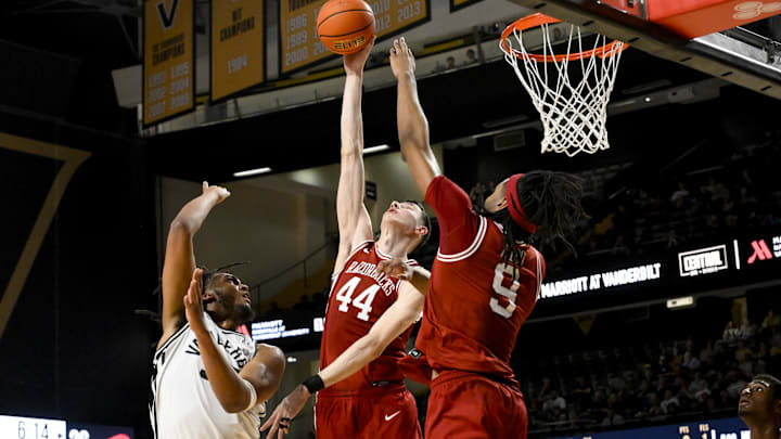 Mar 4, 2025; Nashville, Tennessee, USA;  Arkansas Razorbacks forward Zvonimir Ivisic (44) blocks the shot of  Vanderbilt Commodores forward Devin McGlockton (99) during the first half at Memorial Gymnasium. Mandatory Credit: Steve Roberts-Imagn Images