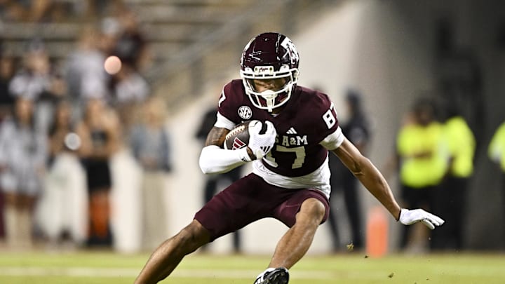Nov 16, 2024; College Station, Texas, USA; Texas A&M Aggies wide receiver Ashton Bethel-Roman (87) runs the ball during the second half against the New Mexico State Aggies at Kyle Field. Mandatory Credit: Maria Lysaker-Imagn Images 