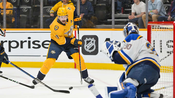Mar 27, 2025; Nashville, Tennessee, USA; St. Louis Blues goaltender Joel Hofer (30) blocks the shot of Nashville Predators left wing Filip Forsberg (9) during the third period at Bridgestone Arena. Mandatory Credit: Steve Roberts-Imagn Images Mar 27, 2025; Nashville, Tennessee, USA; St. Louis Blues goaltender Joel Hofer (30) blocks the shot of Nashville Predators left wing Filip Forsberg (9) during the third period at Bridgestone Arena. Mandatory Credit: Steve Roberts-Imagn Images