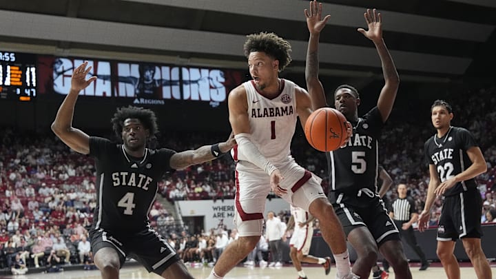 Feb 25, 2025; Tuscaloosa, AL, USA;  Alabama guard Mark Sears (1) drives into the lane and passes as he is defended by Mississippi State forward Cameron Matthews (4) and Mississippi State guard Shawn Jones Jr. (5) at Coleman Coliseum. Alabama defeated Mississippi State 111-73. Mandatory Credit: Gary Cosby Jr.-Tuscaloosa News