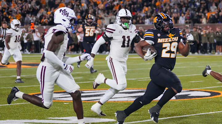 Nov 15, 2025; Columbia, Missouri, USA; Missouri Tigers running back Ahmad Hardy (29) runs for a touchdown as several Mississippi State Bulldogs defenders chase during the second half of the game at Faurot Field at Memorial Stadium. Mandatory Credit: Denny Medley-Imagn Images Nov 15, 2025; Columbia, Missouri, USA; Missouri Tigers running back Ahmad Hardy (29) runs for a touchdown as several Mississippi State Bulldogs defenders chase during the second half of the game at Faurot Field at Memorial Stadium. Mandatory Credit: Denny Medley-Imagn Images