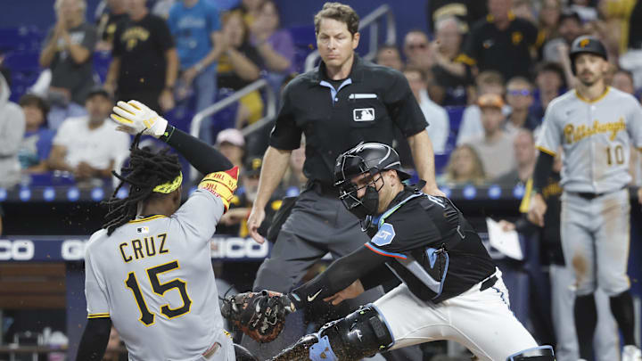 Mar 29, 2025; Miami, Florida, USA;  Miami Marlins catcher Nick Fortes (4) tags Pittsburgh Pirates outfielder Oneil Cruz (15) at the plate during the first inning at loanDepot Park. Mandatory Credit: Rhona Wise-Imagn Images