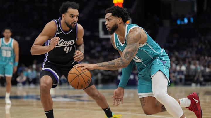 Apr 4, 2025; Charlotte, North Carolina, USA; Charlotte Hornets forward Miles Bridges (0) drives to the basket against Sacramento Kings forward Trey Lyles (41) during the second half at Spectrum Center. Mandatory Credit: Jim Dedmon-Imagn Images