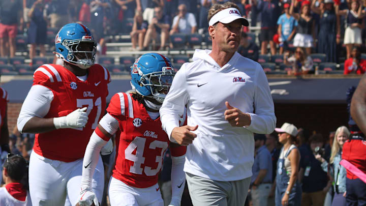 Oct 11, 2025; Oxford, Mississippi, USA; Mississippi Rebels head coach Lane Kiffin leads his team out of the tunnel prior to the game against the Washington State Cougars at Vaught-Hemingway Stadium. Mandatory Credit: Petre Thomas-Imagn Images